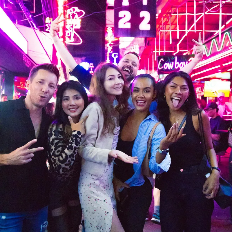 Group enjoying sunset drinks at a Bangkok rooftop bar before a tuk tuk bar crawl on this nightlife tuk tuk tour Bangkok Thailand